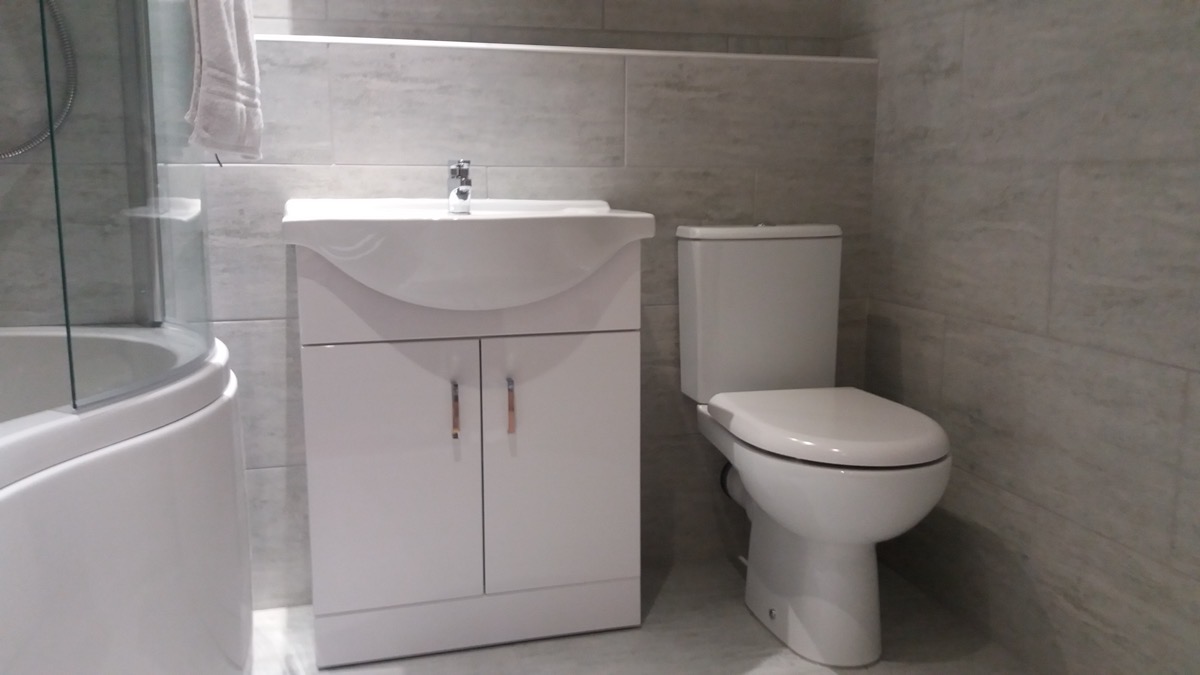 Tiled family bathroom with bath