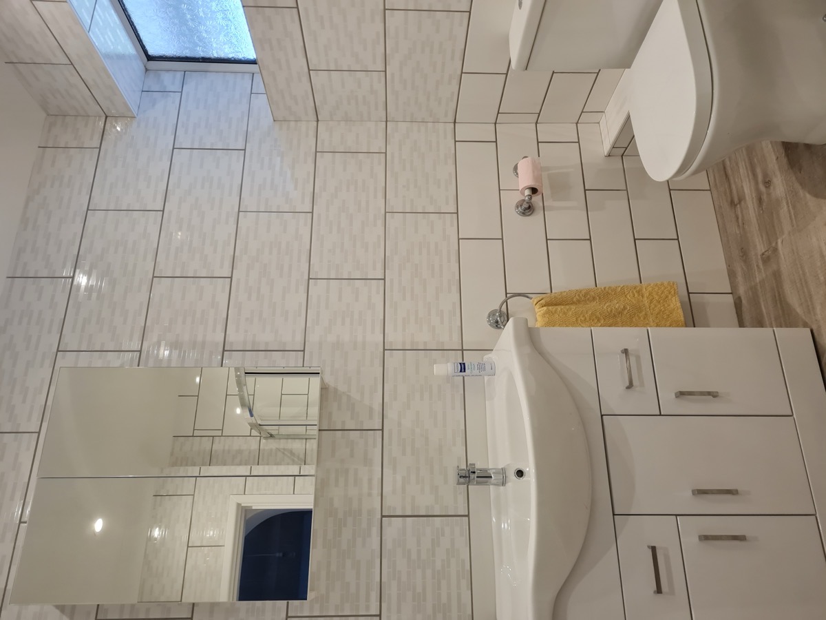Tiled shower room with glass screen