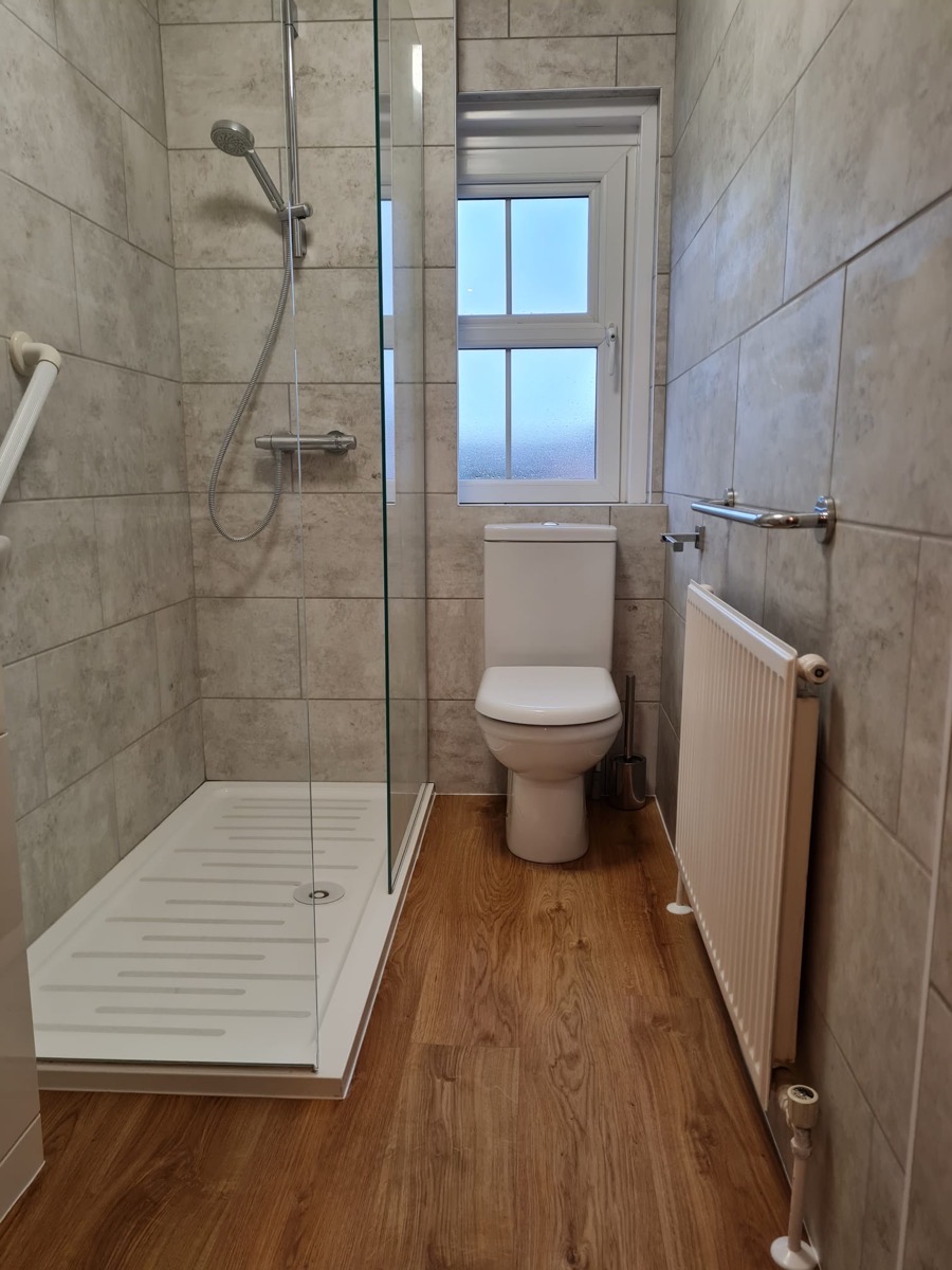 Shower room with grey tiling and vinyl flooring