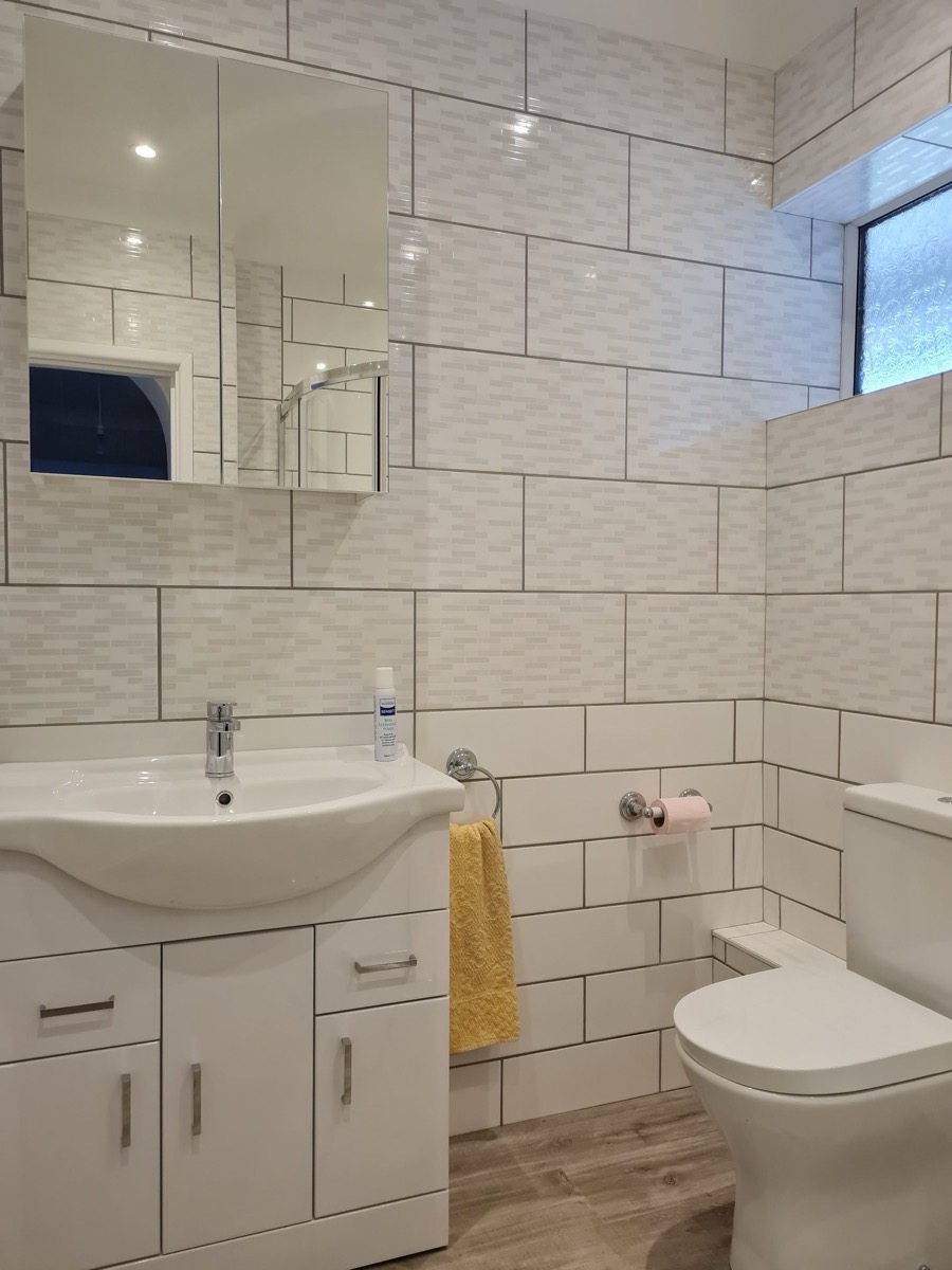 Complete bathroom with vanity and tiling