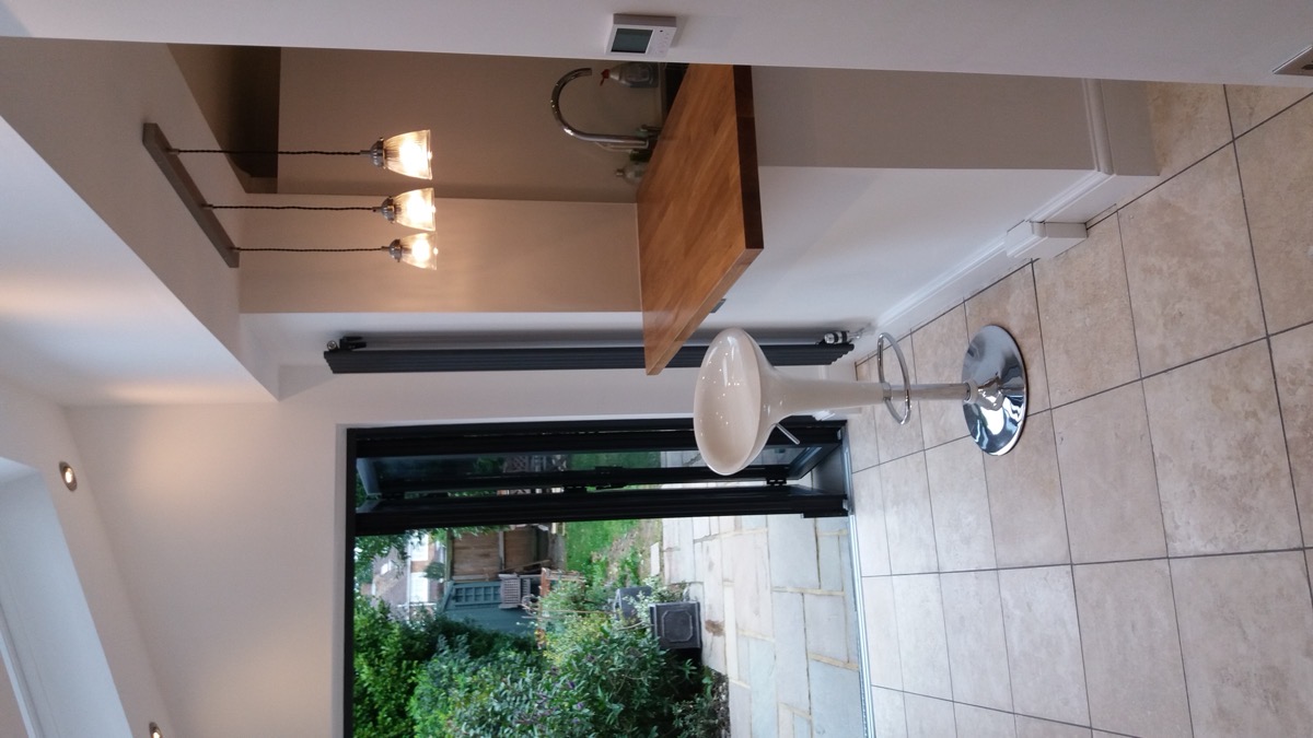 White fitted kitchen with built-in oven