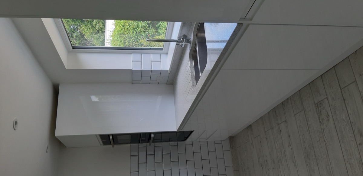 White kitchen with breakfast bar and appliances