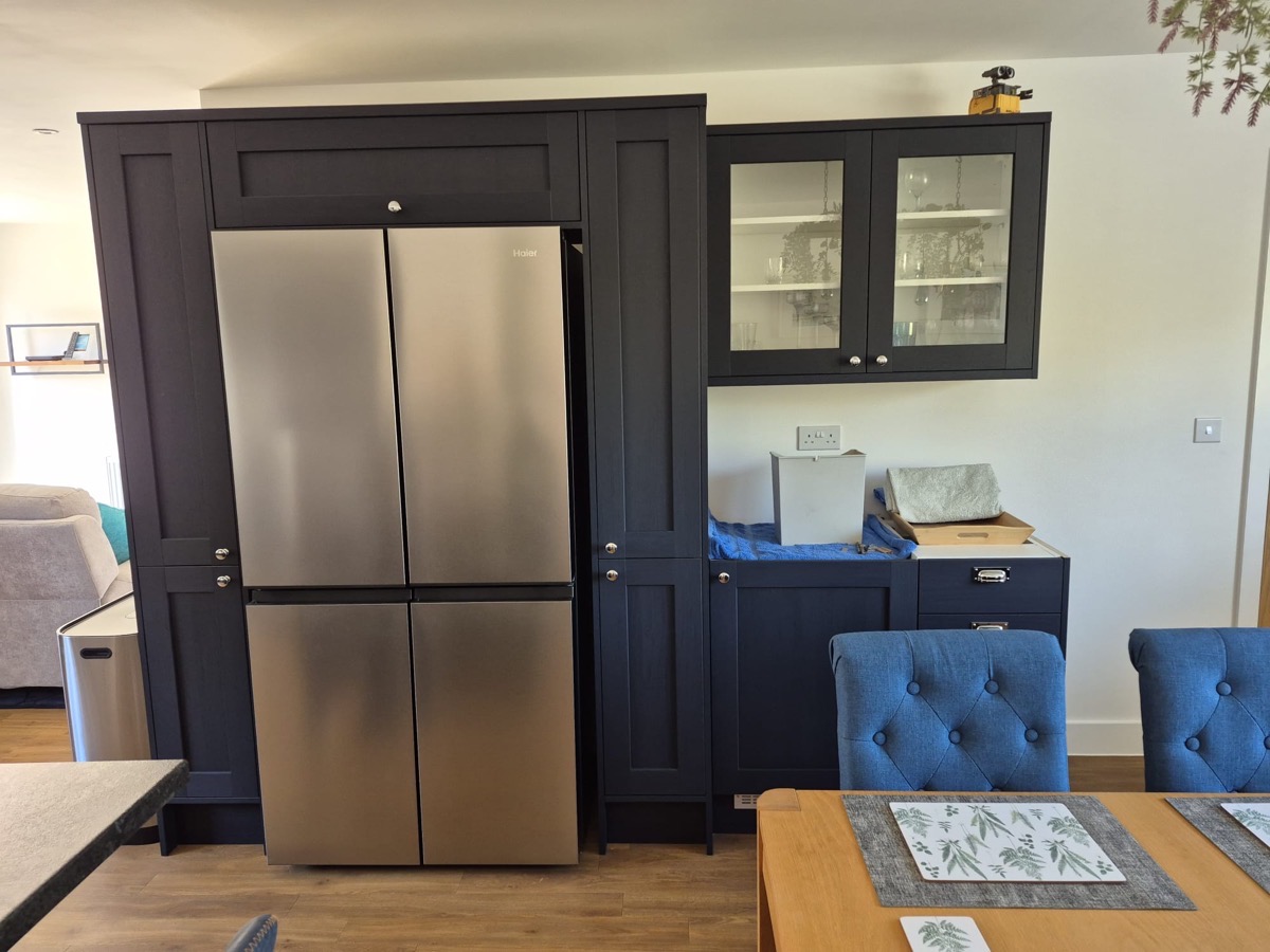 Navy blue shaker kitchen with integrated American fridge