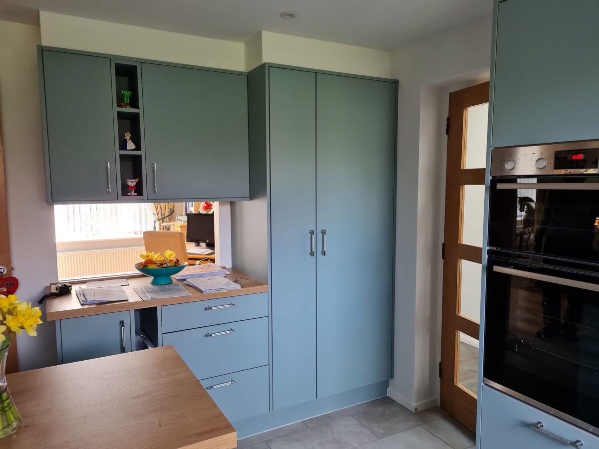 Teal shaker kitchen with oak worktops