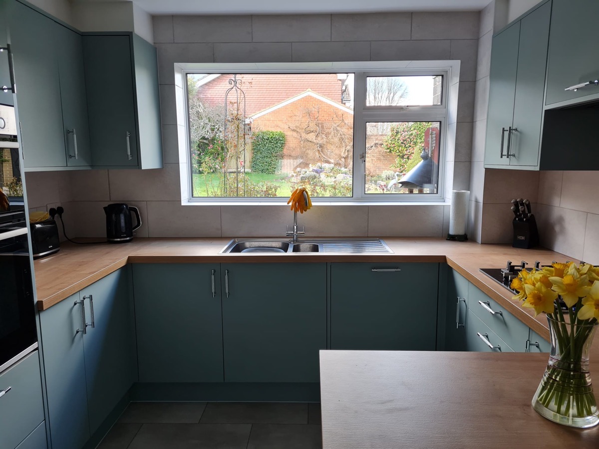 Teal kitchen sink and window view