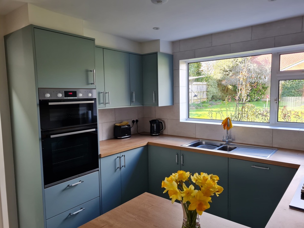 Teal kitchen with double oven tower
