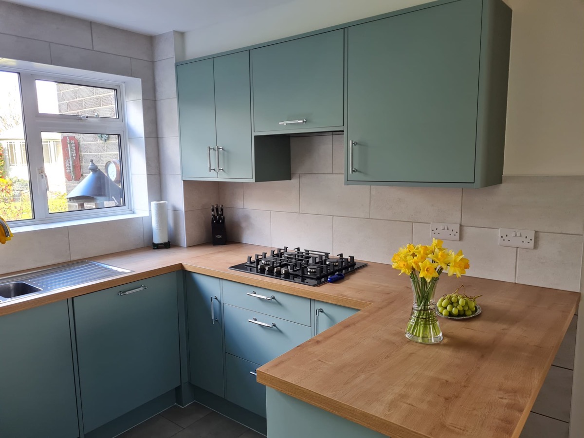Teal kitchen hob and countertop detail