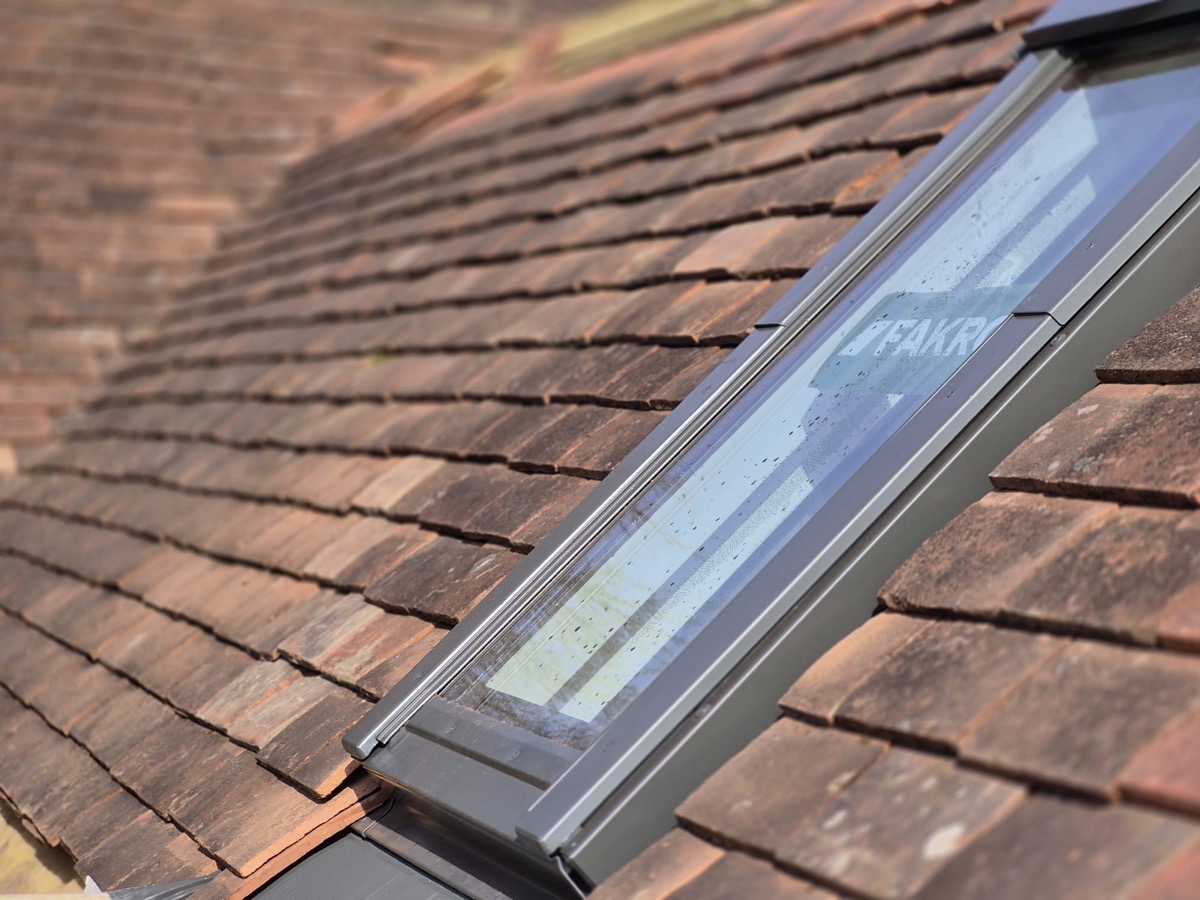 Roof window installation in reclaimed clay tile roof