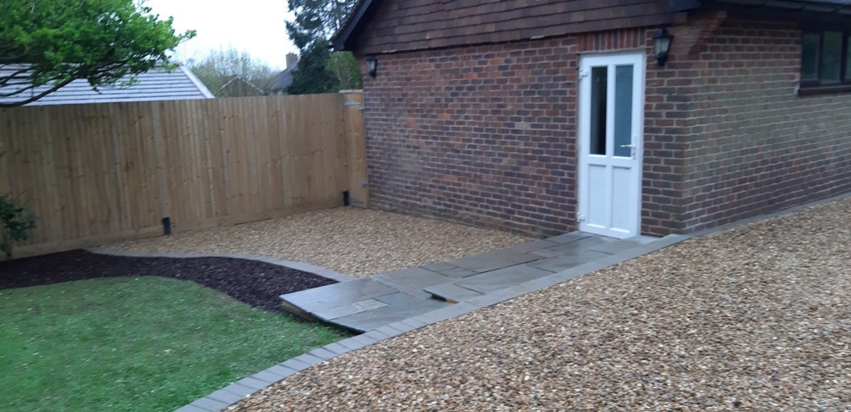 Stone paving pathway with timber fencing